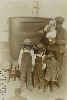  From left to right, Lester Henry Turner (son), Wesley Woodson Turner (son), Charles Edward Turner (son), and Perry Woodson Turner (father) holding Perry Raymond Turner (1927-1928).